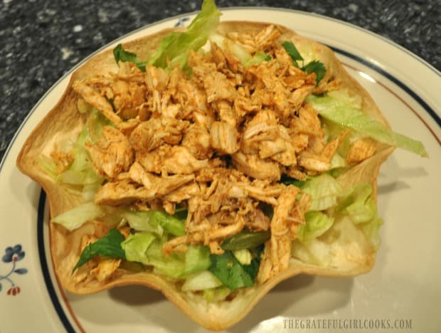 Seasoned chicken in tortilla taco bowl