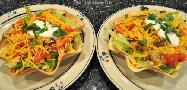 Two chicken taco salads on plates