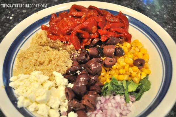 Quinoa, feta, olives, corn, etc. in salad bowl