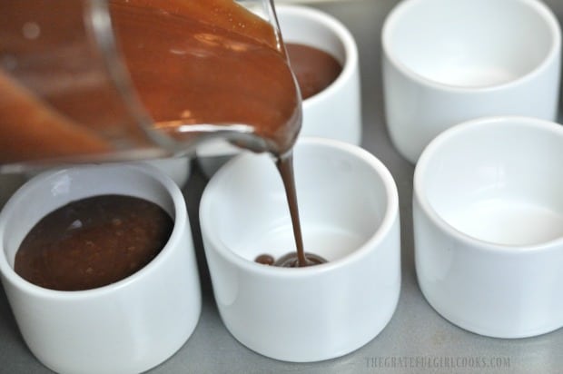Pouring blended chocolate into small serving pots