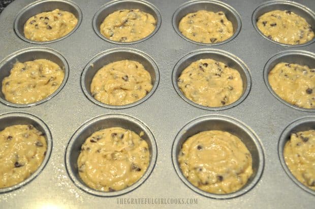 Muffin batter in metal muffin tin cup holders