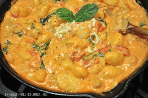 Italian Sausage Gnocchi in cast iron skillet with wooden spoon