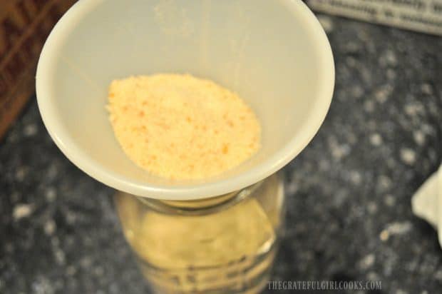 Funnel is used to transfer bread crumbs into jar