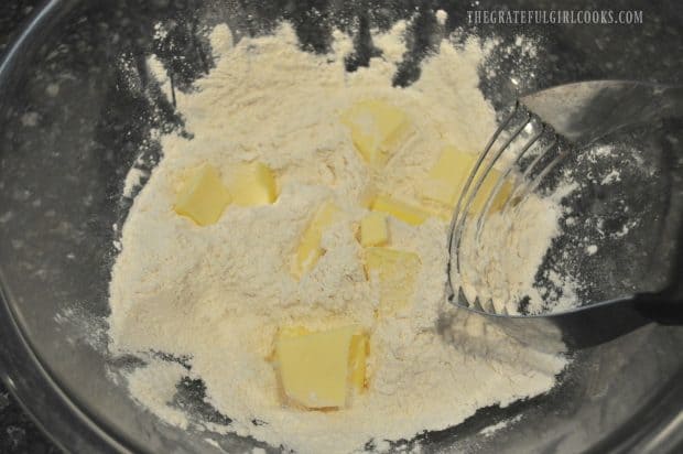Butter is cut into flour for scone dough