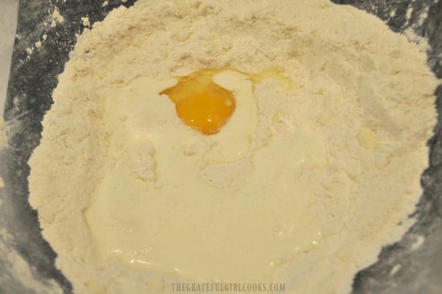 Egg and whipping cream is added to dry ingredients for scones