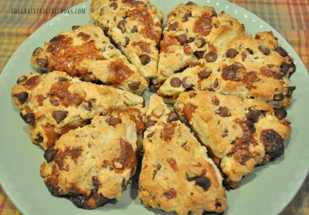 Baked chocolate caramel pecan scones on green serving plate