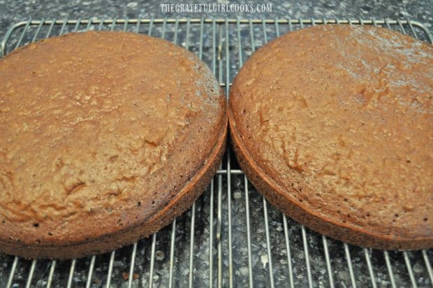 Two baked cake layers, cooling on wire rack