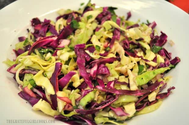 Mixed cabbage slaw for fish tacos, in a white bowl
