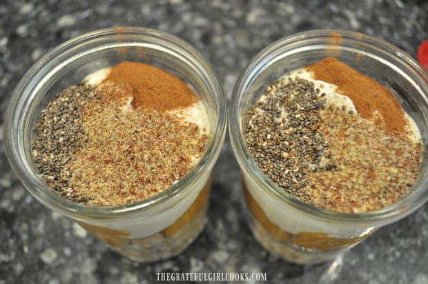 Yogurt, chia seeds, cinnamon and flaxseed added to oats in jar