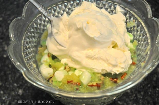 Whipped topping is stirred into fluff salad ingredients