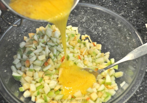 Egg, oil and vanilla added to apple muffin mixture in bowl