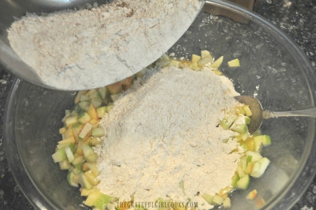 Flour and spices added to muffin mixture in bowl