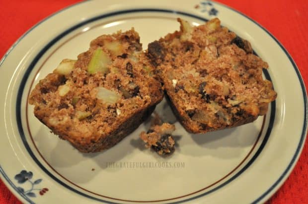 Apple raisin muffin cut in half, on a plate