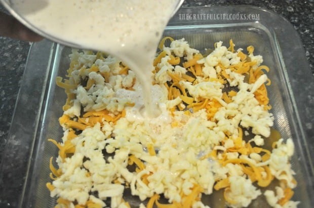 Pouring milk/flour mixture over chile relleno casserole before baking