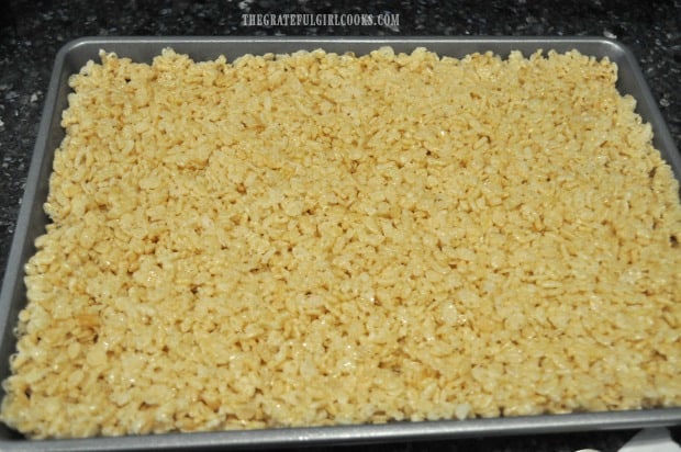 Krispy bars pressed into pan, ready for chocolate peanut butter frosting