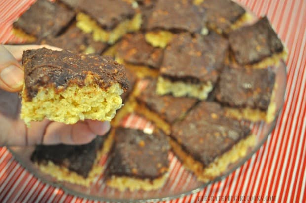 Holding krispy bar above platter of goodies