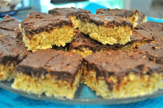 Platter of chocolate peanut butter krispy treats, on blue cloth