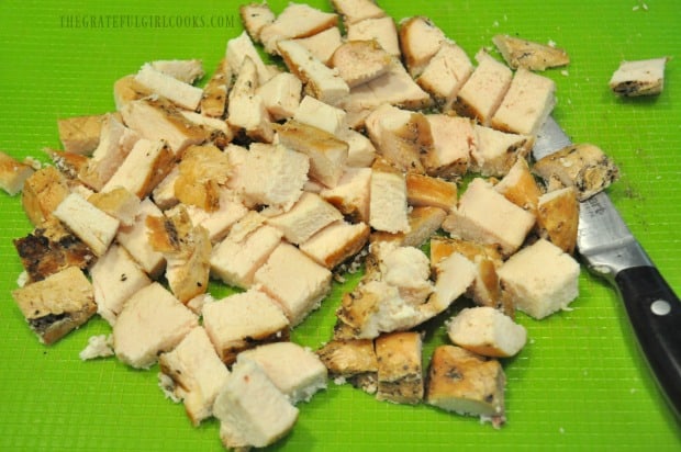 Cooked chicken breasts are cut into cubes before adding to alfredo sauce.