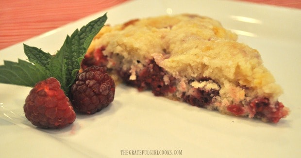 Slice of raspberry lemon crumb cake, with fresh raspberries and mint garnish.