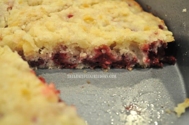 The inside look at a slice of this raspberry cake in pan.