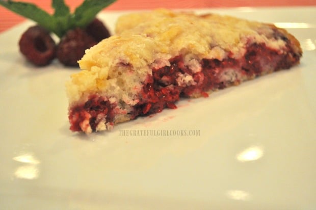 A slice of raspberry lemon crumb cake, served on a white plate