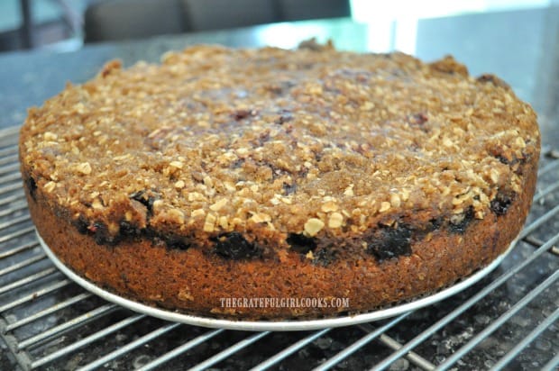 The triple berry streusel coffeecake is baked and cooling on a wire rack.