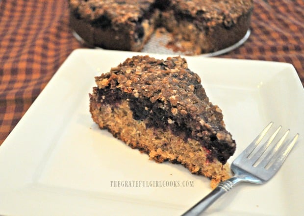 A piece of the coffeecake on a white plate.