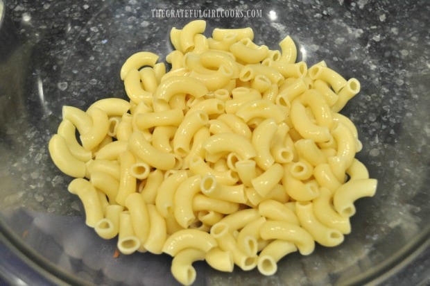 Elbow macaroni is cooked and drained for pasta salad