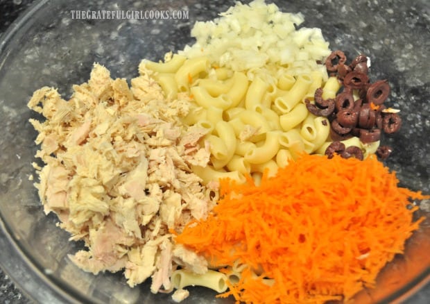 Pasta with tuna, onion, kalamata olives and shredded carrots ready to combine