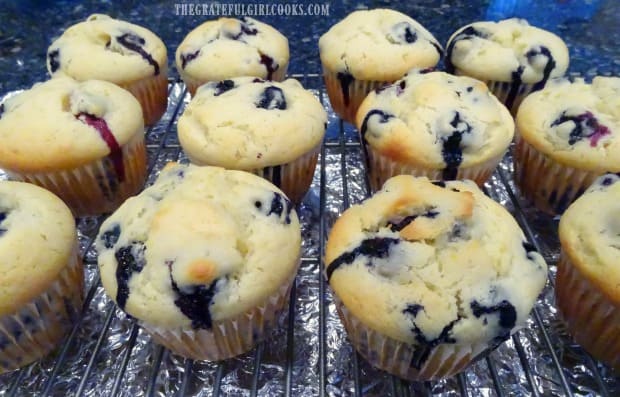 Baked blueberry lemon muffins, cooling on a wire rack.