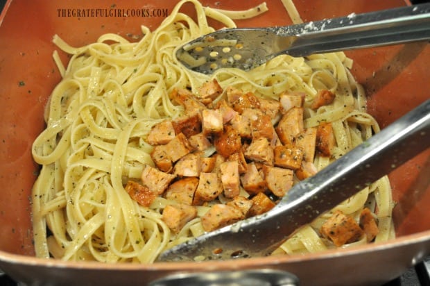 Cooked chicken Italian sausage pieces are tossed into seasoned pasta.