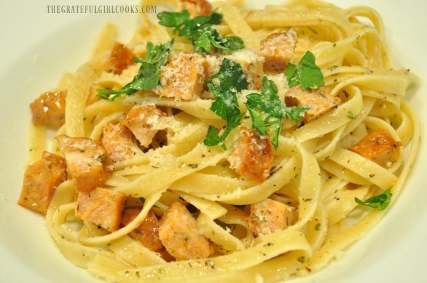 The finished simple chicken sausage pasta is garnished with Parmesan cheese and fresh parsley.