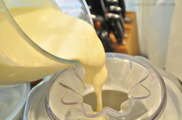 Peach ice cream mixture is added to ice cream machine.