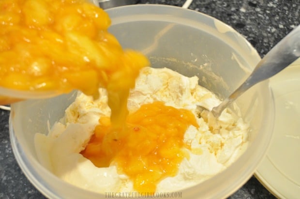 Cold reserved peaches are added to finished ice cream and stirred in.