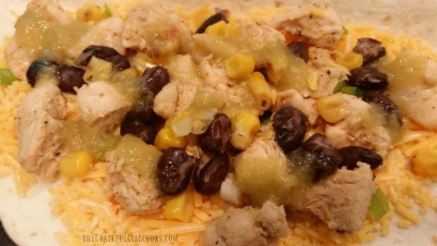 Green sauce (salsa verde) is added to chicken black bean quesadilla.