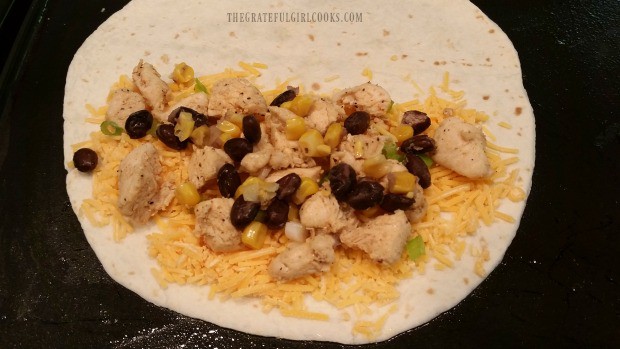 Black beans and corn are added to tortilla for chicken black bean quesadilla.