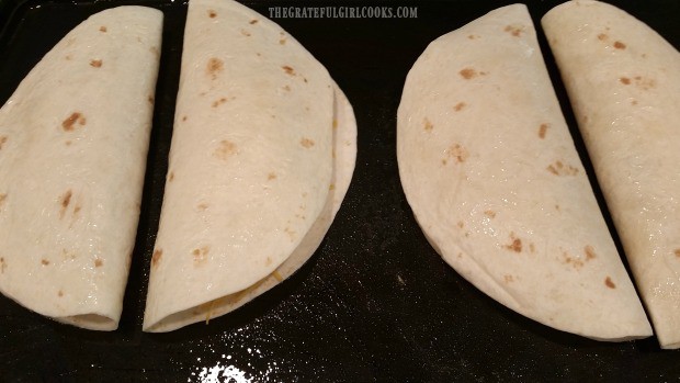 Each chicken black bean quesadilla is folded in half and place on griddle to cook.