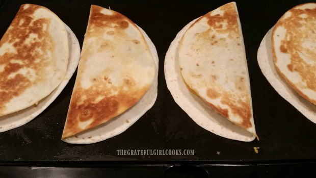 Each chicken black bean quesadilla is turned to other side when golden brown during cooking.