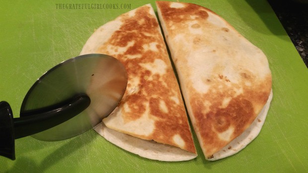 Each chicken black bean quesadilla is sliced using a pizza cutter, when done.