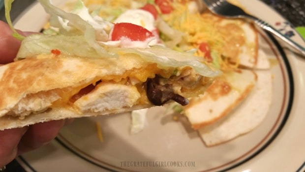 Side view of a slice of chicken black bean quesadilla.