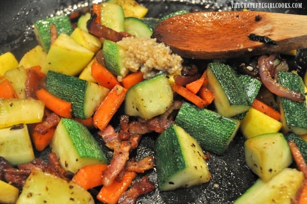 Minced garlic is added to sauteéd summer squash.