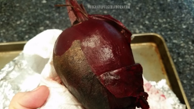 Skin is removed from oven roasted beets by rubbing with paper towels.