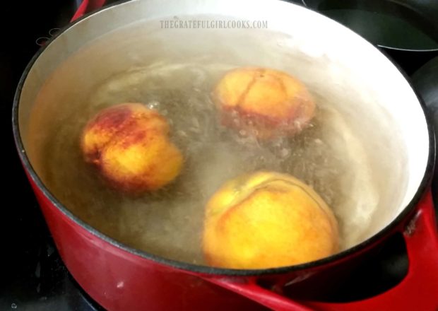 Peaches placed in boiling water to help remove peels.