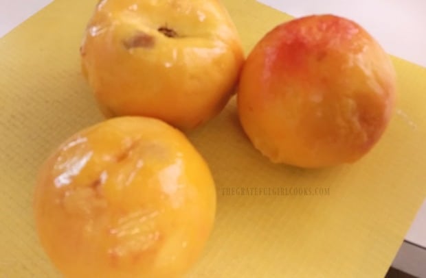 Peeled peaches, ready to be sliced for canning.