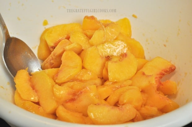 Fresh peaches are peeled, pitted, sliced and then chopped to add to ice cream base.