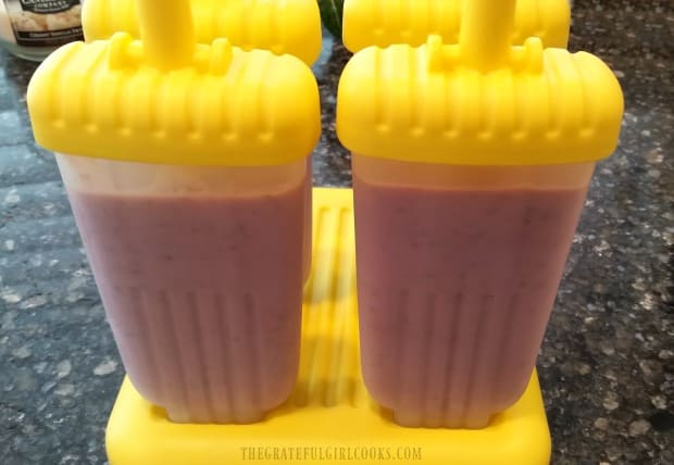 Fruit Smoothie popsicles, with lids on, ready to freeze!
