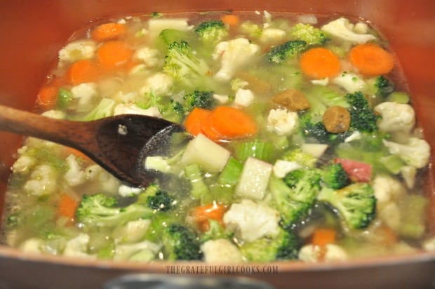 Vegetables for chowder cooked in chicken broth.