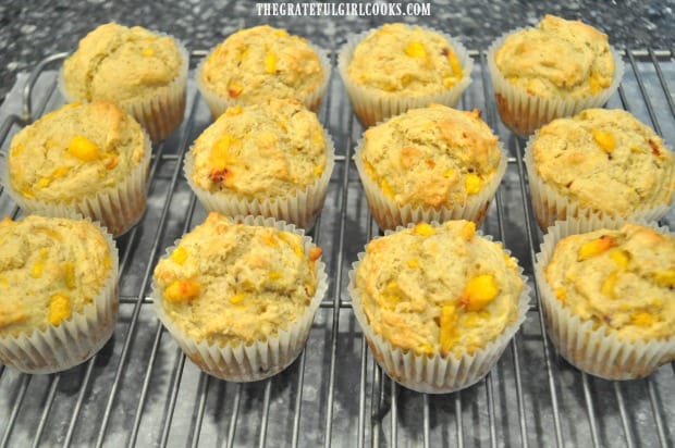 Peach jam muffins cool down on wire rack before adding glaze.