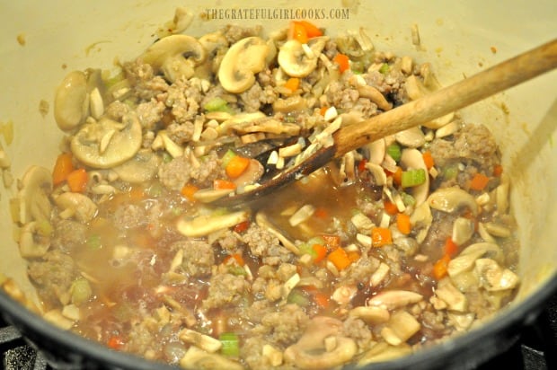 Chopped mushrooms, red wine, and broth are added to make ragu sauce.