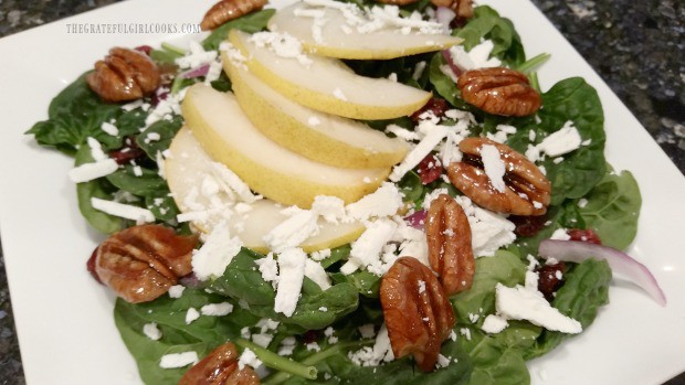 Candied pecans, goat cheese and sliced pear added to spinach salad.